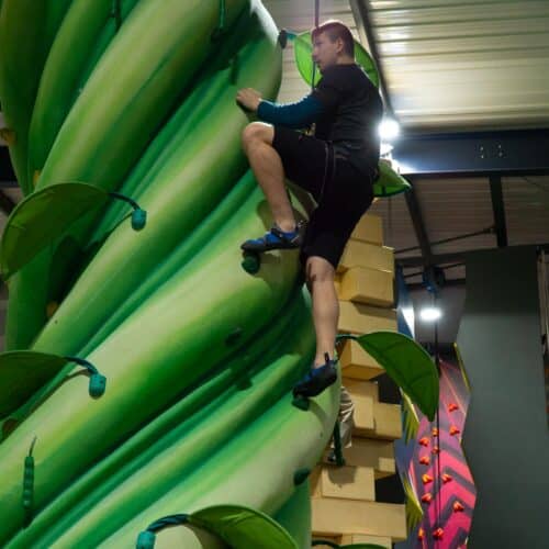 Boy at a boudering competition at an indoor climbing centre in Swansea.