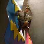 Exited boy training at an indoor climbing facility in Swansea.