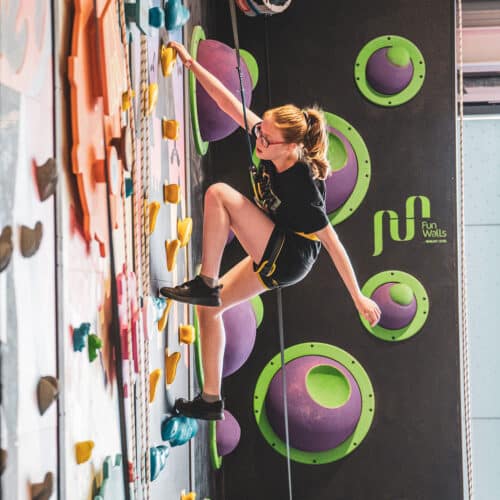 Girl climbing at Crazy Climb Swansea's indoor play area.