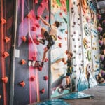 Kids on a climbing wall at Crazy Climb Swansea's indoor activities centre